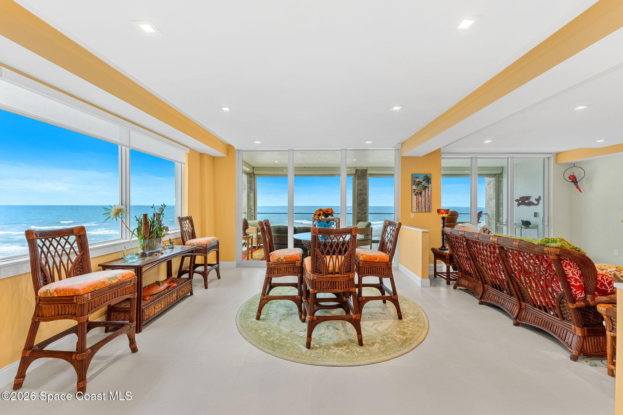 Dining area opening to the oceanfront balcony
