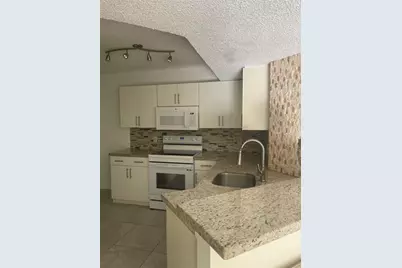 8801 Wiles Road #208, Coral Springs, FL 33067 - Photo 1